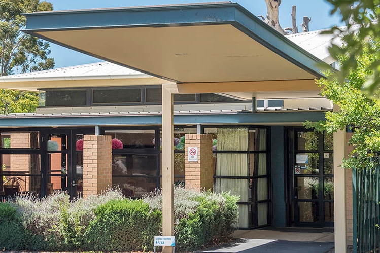 The entrance to the Villa Maria aged care home building, with lavender plants in the garden.