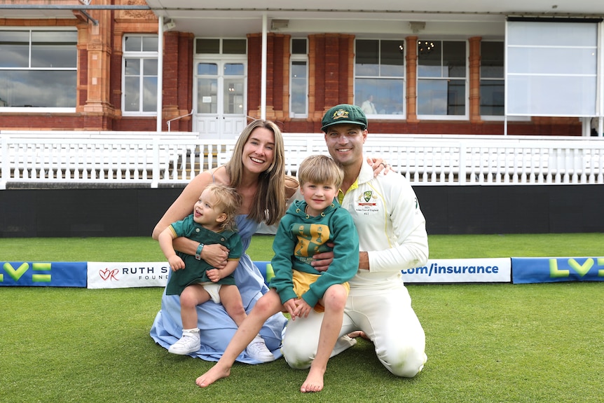 Alex Carey and wife Eloise sit with their daughter and son on the turf at Lord's