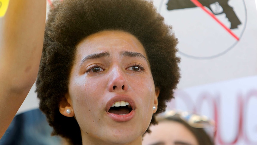 A woman cries as she listens to a fiery speech at the rally