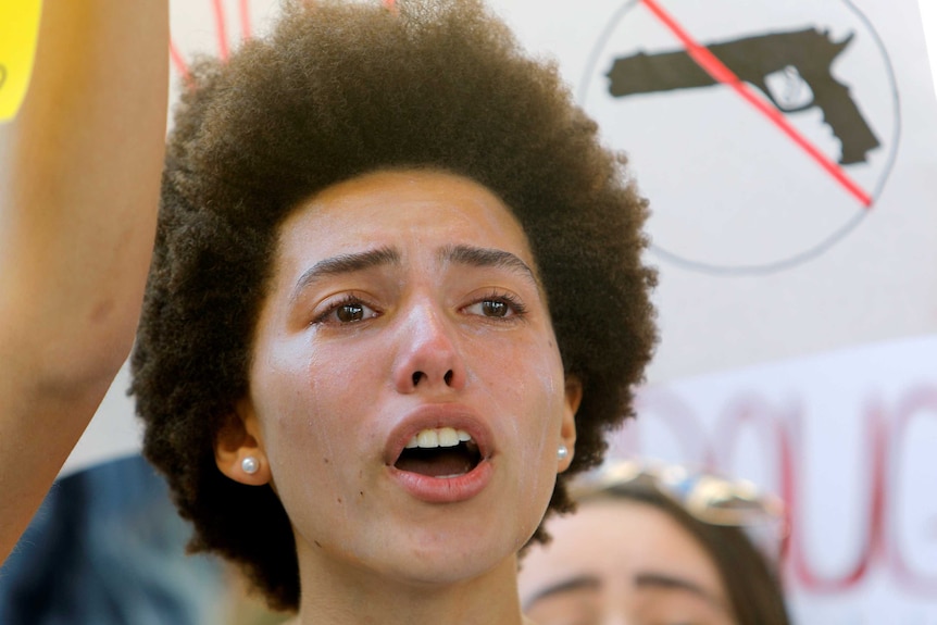 A woman cries as she listens to a fiery speech at the rally