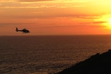 A helicopter floating above the sea