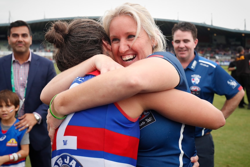 Western Bulldogs AFLW manager Debbie Lee embraces a player after winning the 2018 Grand Final.