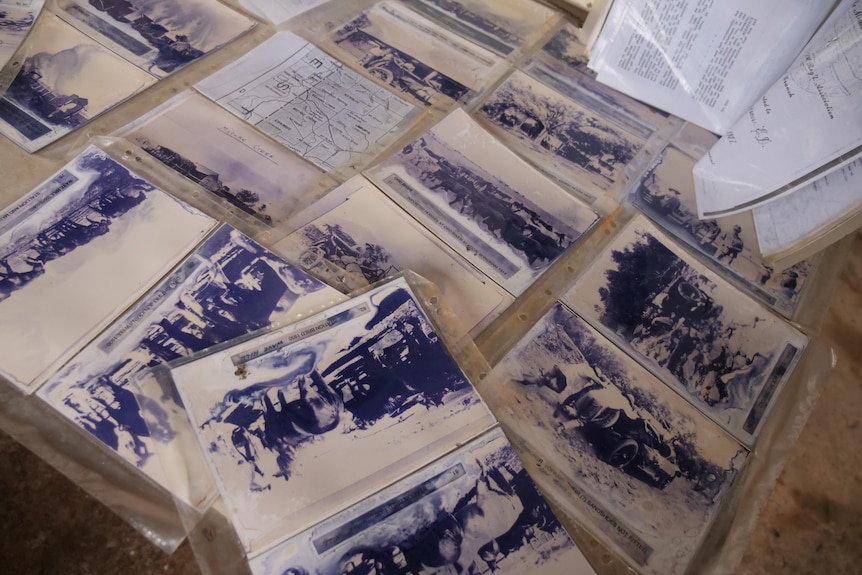 Old photographs displayed on a table. 