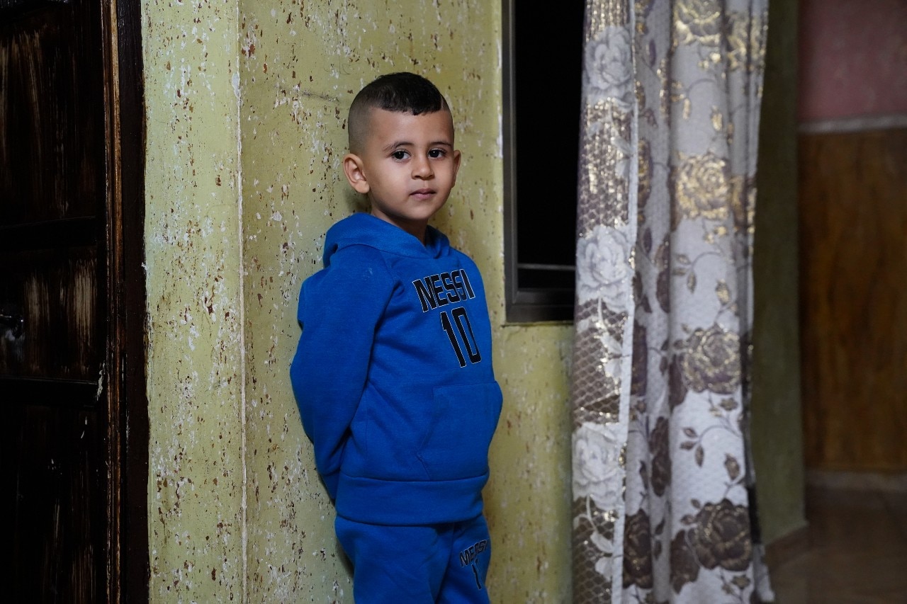  A young boy leaning against a wall