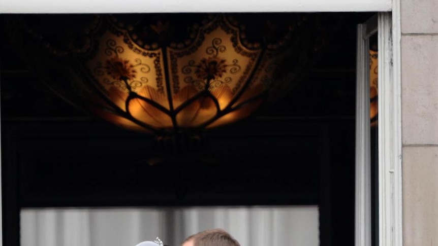 Prince William, Duke of Cambridge, and Catherine, Duchess of Cambridge, kiss on the balcony