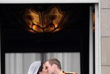 Prince William, Duke of Cambridge, and Catherine, Duchess of Cambridge, kiss on the balcony