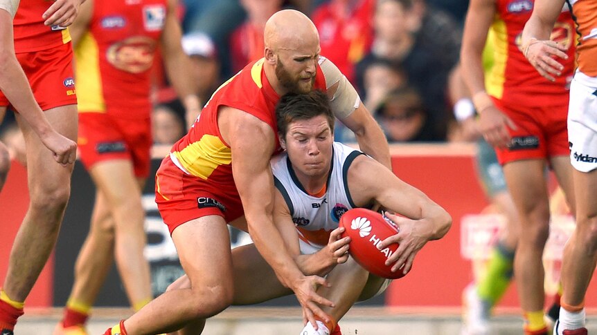 Suns player Gary Ablett tackles Giants player Toby Greene