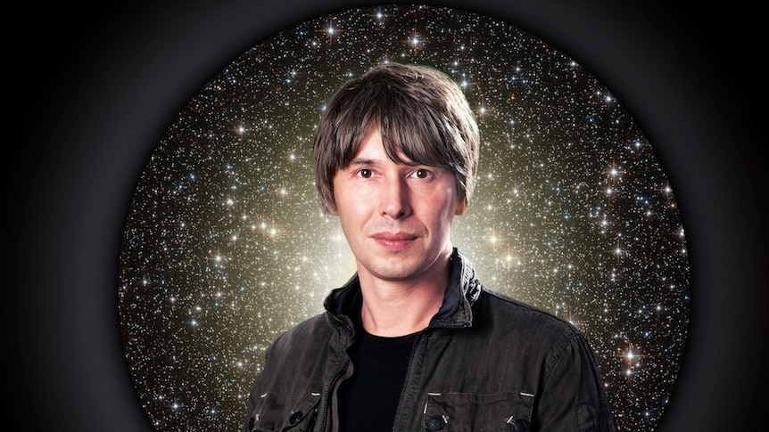 Renowned physicist Professor Brian Cox standing in front of a starry back drop.