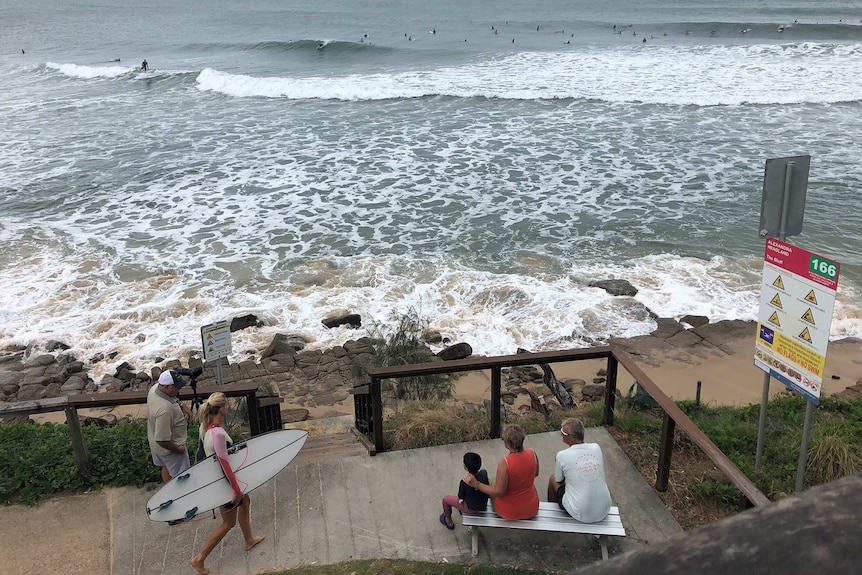 Surfers ride waves at Alexandra Headland.