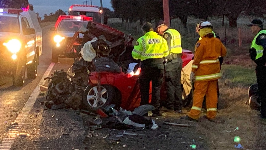 Photograph of emergency service workers and a bad car crash on the side of a road