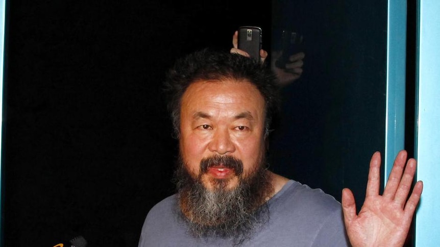 Ai Weiwei greets media after release