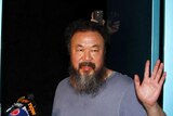 Ai Weiwei greets media after release