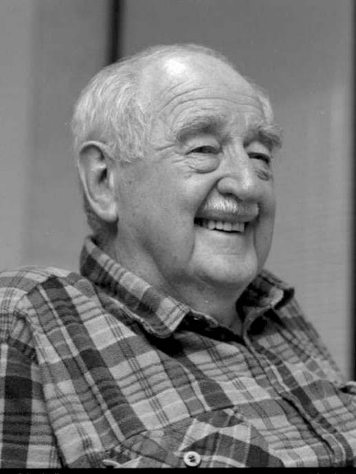 Black and white photo of semi bald man smiling/laughing