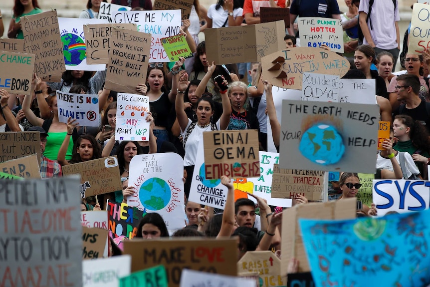 A large number of protestors hold placards in Athens, Greece.