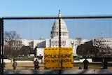 National guards are seen behind a fence that was erected to reinforce security at the Capitol in Washington.