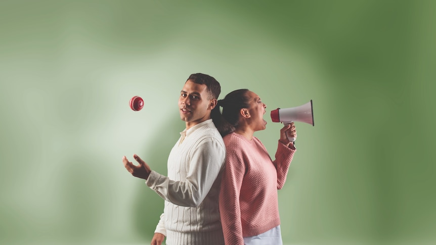 A man in a cricket uniform throwing a cricket ball in the air stands back-to-back with a woman shouting into a megaphone.