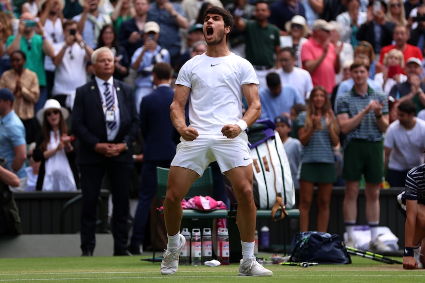Carlos Alcaraz roars and flexes on Wimbledon's Centre Court.