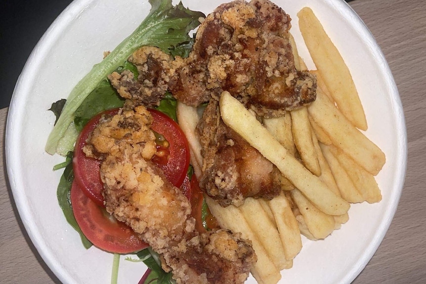 A meal including chips on a plate in an Adelaide medi-hotel.