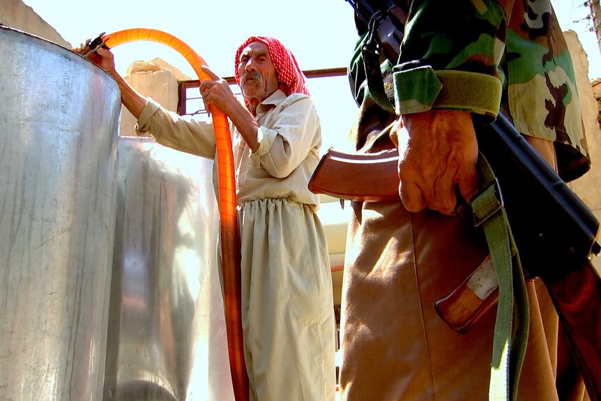 Old man loading water in Sinjar