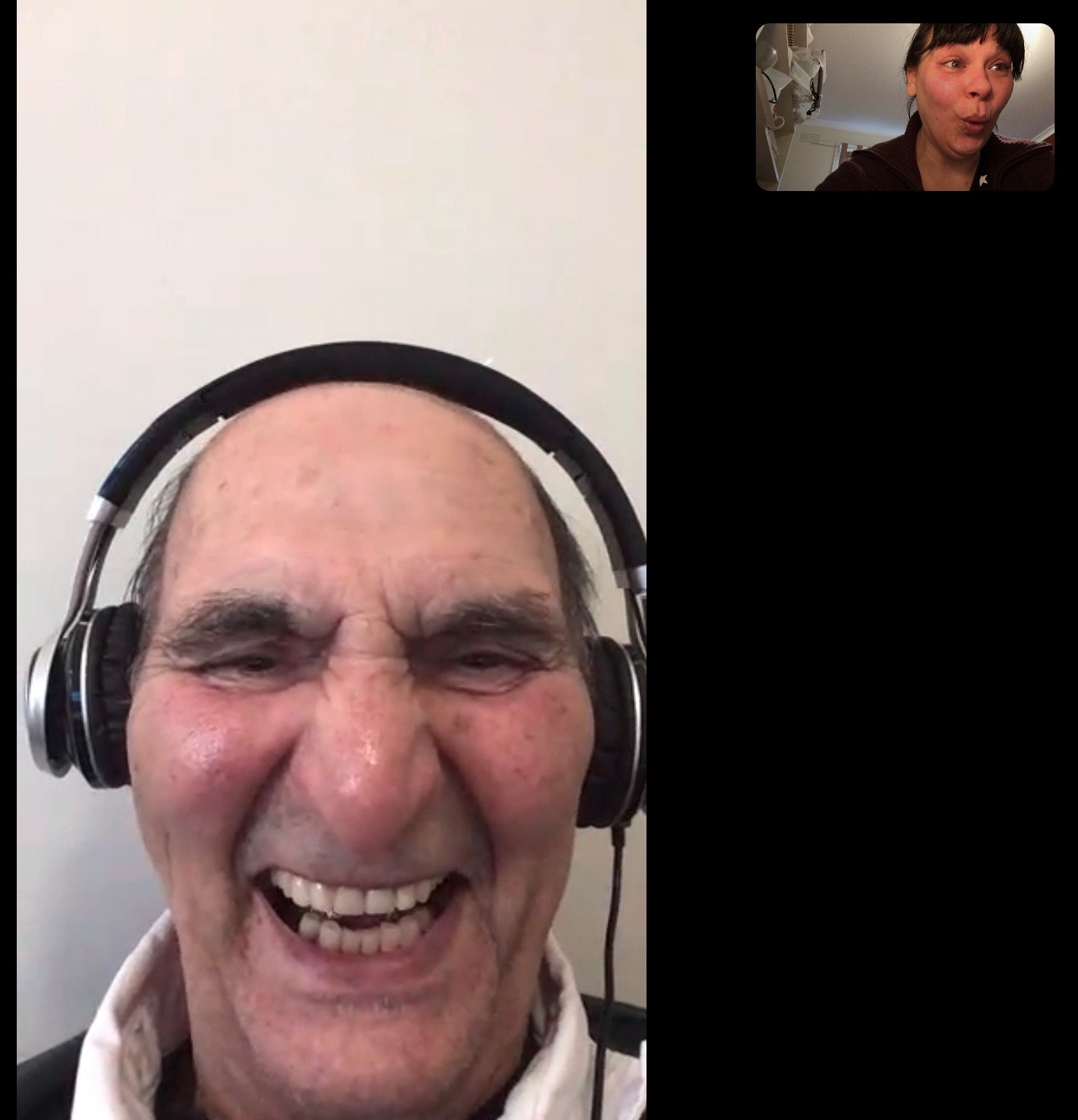 Screenshot of a video chat with an old man wearing headphones a younger woman talking in a smaller screen