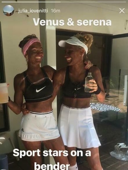 Two young white women seen with blackface dressed in tennis costumes.