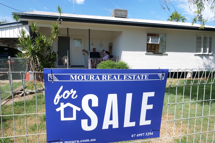 A 'for sale' sign in the front of a house
