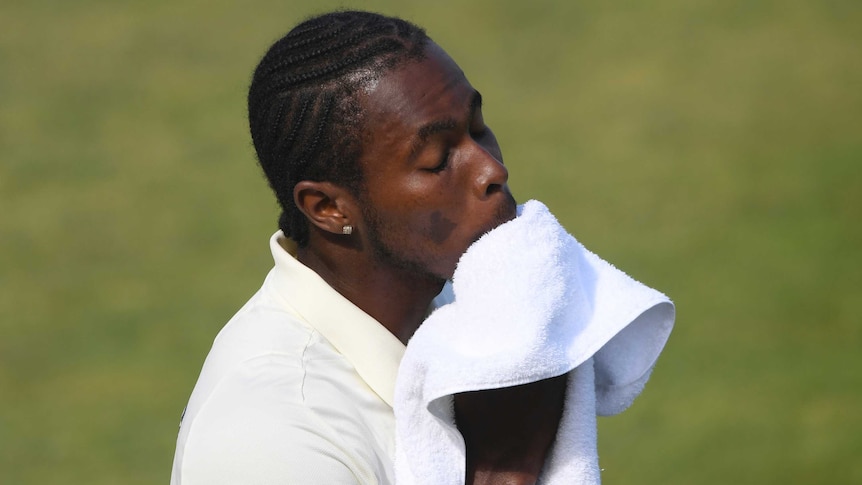 Jofra Archer wipes his face with a white towel