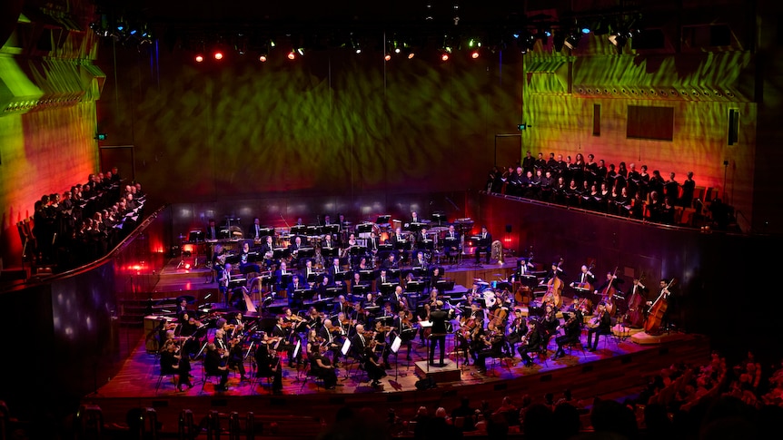 The Melbourne Symphony Orchestra on stage at Hammer Hall with the Melbourne Symphony Chorus standing in the choir stalls above