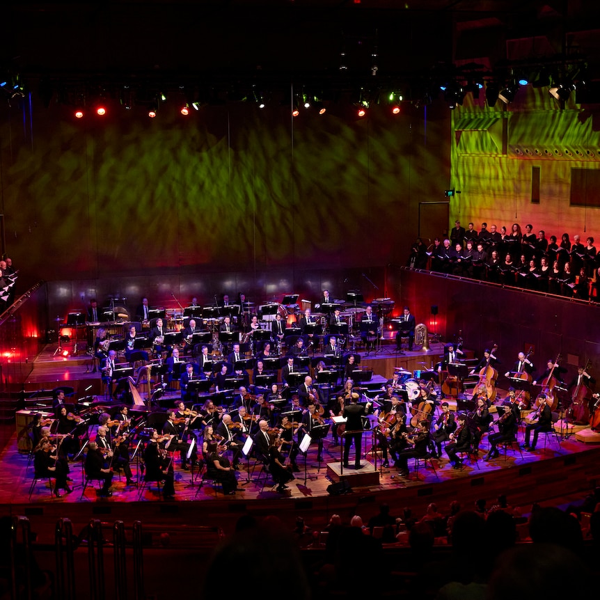 The Melbourne Symphony Orchestra on stage at Hammer Hall with the Melbourne Symphony Chorus standing in the choir stalls above
