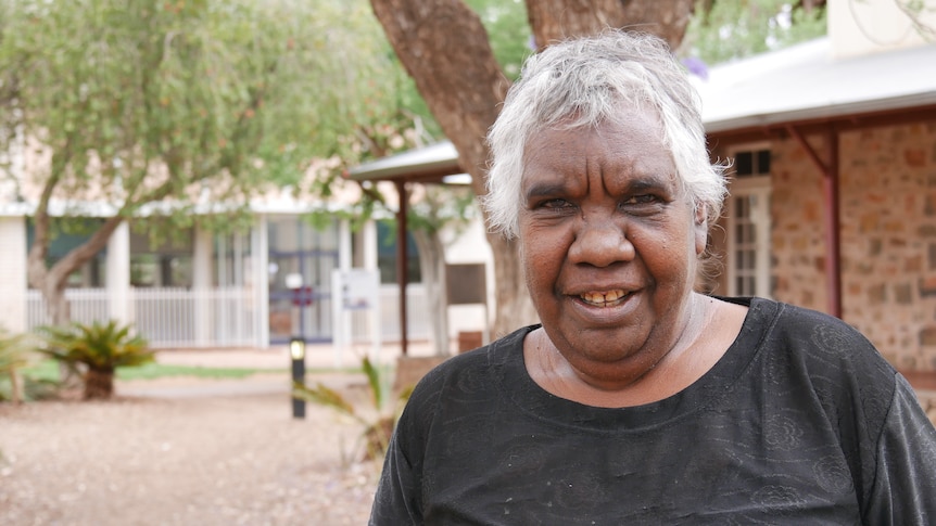 Health worker Jillian Kantawarra is wearing a black shirt and looking at the camera with a serious expression