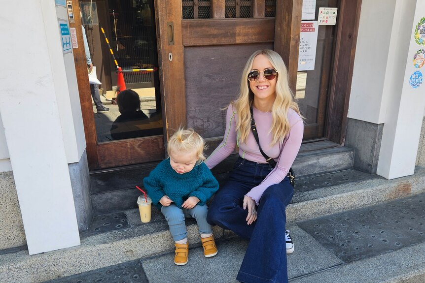 Kellie with her son Lane sitting on some steps