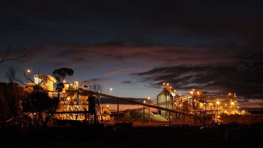 Gold mining operations lit up against the dark night time sky.