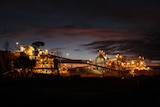 Gold mining operations lit up against the dark night time sky.