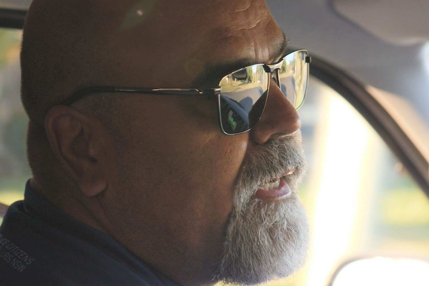 Man with beard and sunglasses close up in a bus