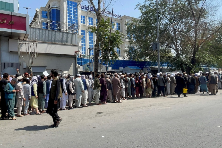 a line of people outside a building