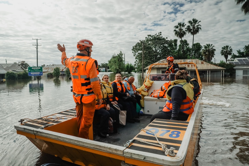 SES volunteers on a boat in floodwater