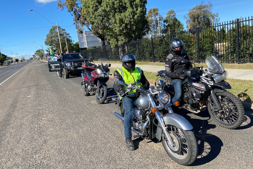 Men on motorbikes wearing safety gear.