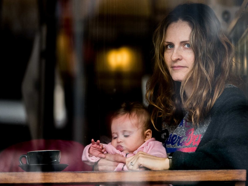 Giselle Haber holds her baby daughter Luna Haberin cafe