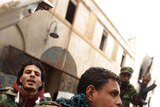 Rebellion: Opposition fighters patrol the streets in Libya.
