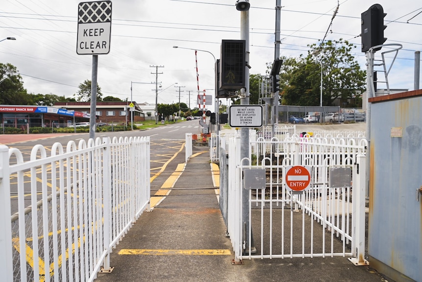 A level crossing through the white gates that close when a train is approaching. 