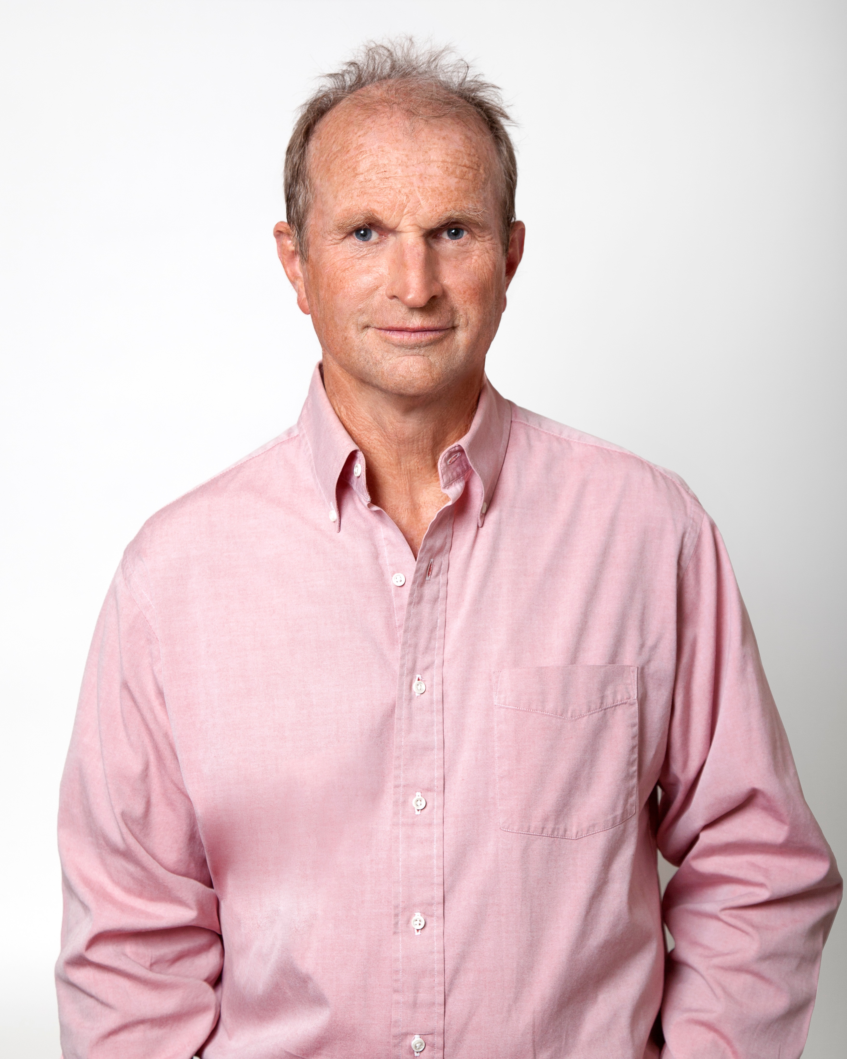 A man, Ross Headifen, wearing a pink button up shirt.