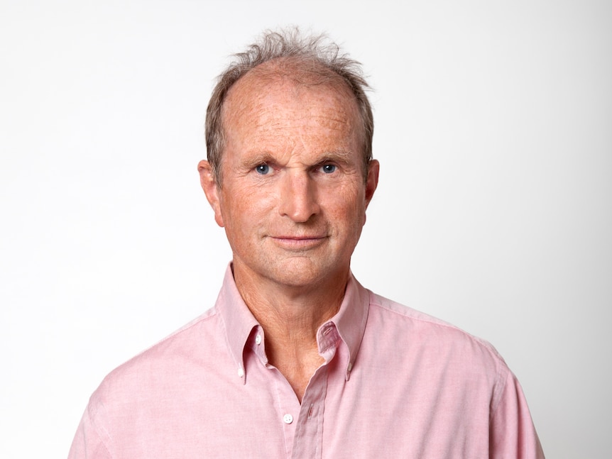 A man, Ross Headifen, wearing a pink button up shirt.