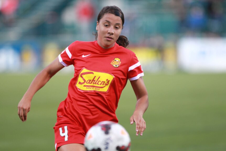 A close up of soccer player Sam Kerr staring intently at the ball during play for the Western New York Flash.