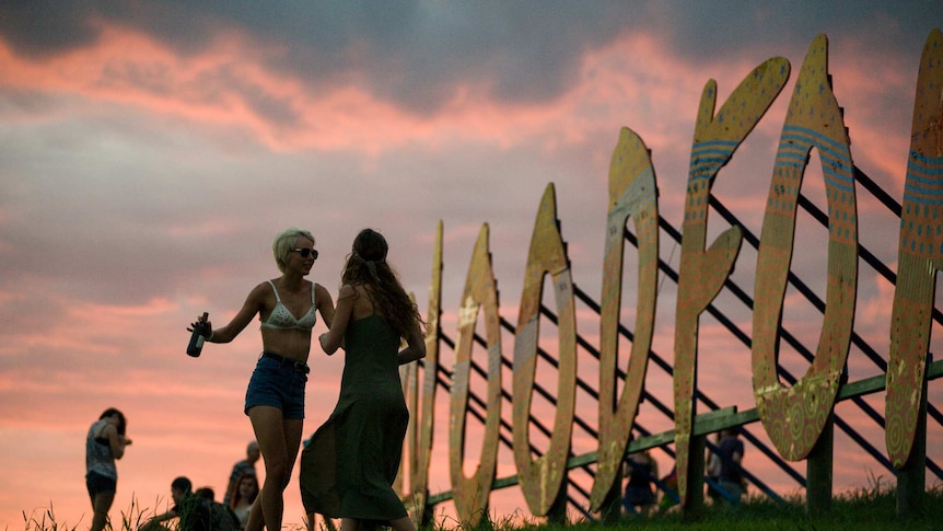 Revellers see in the dawn atop the hill overlooking the Woodfordia site