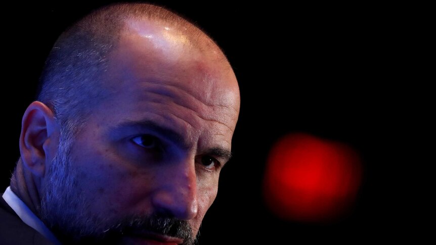 A close up of Uber CEO Dara Khosrowshahi shows him looking serious.