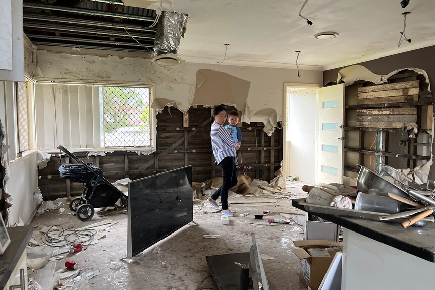 Sandy Xia and son Nulan in their flood damaged home.