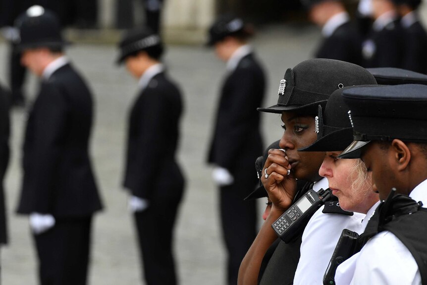 Three officers mourn PC Palmer.