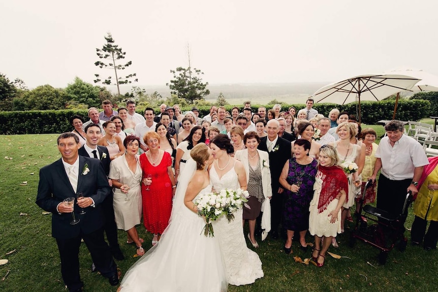 Kate Mackie (bridge on left) and Leonie Clark kiss at their wedding on November 11, 2011.