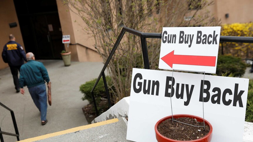 Two signs point to a Gun buy Bakc area