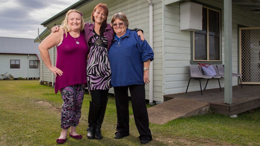 Dee Threlfo, Tina Kemp and Robyn Baker stand outside a building.